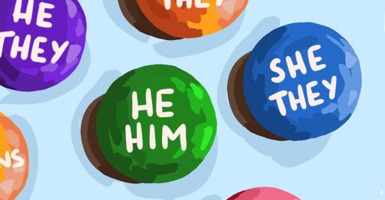 Colorful round buttons with different pronouns printed on them, including ‘He/Him,’ ‘She/Her,’ ‘They/Them,’ and ‘Use My Name